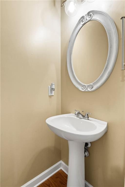 bathroom with wood-type flooring and sink