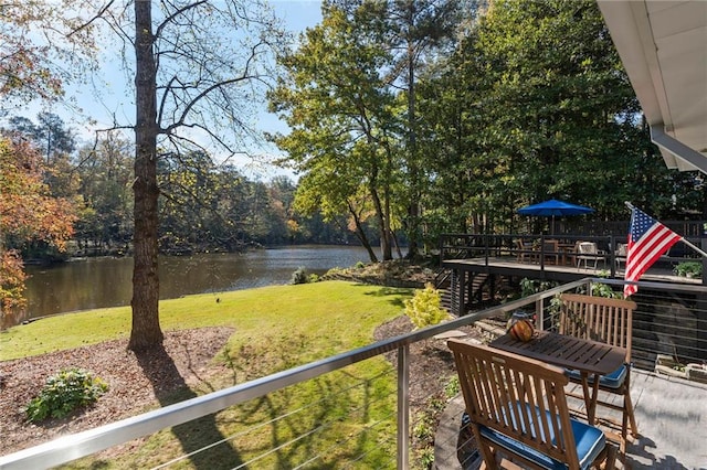 exterior space featuring a lawn and a water view