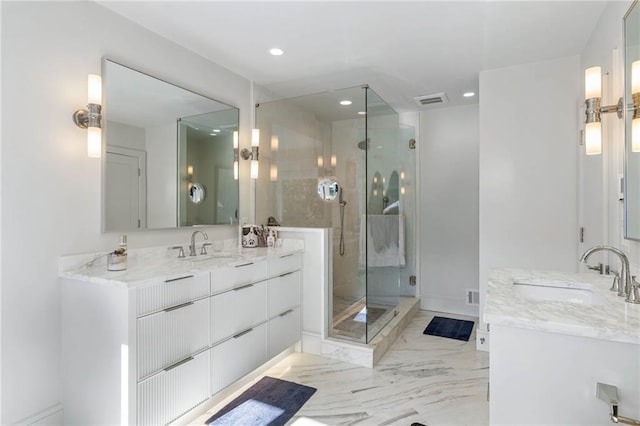 bathroom featuring vanity and a shower with door