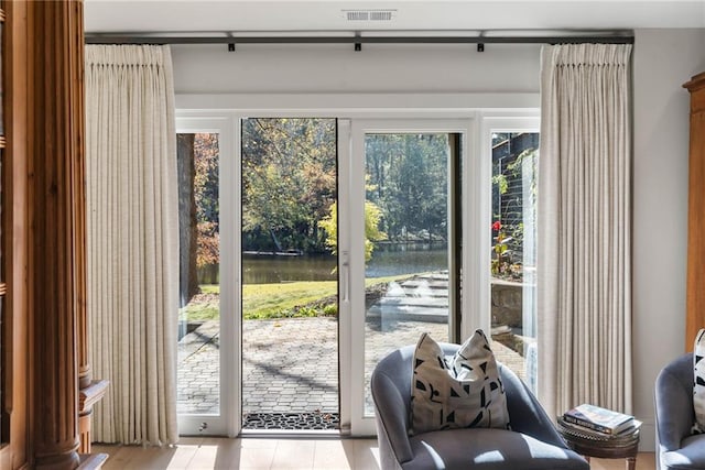 doorway to outside featuring a water view