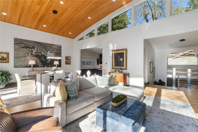 living room featuring high vaulted ceiling, wooden ceiling, and an inviting chandelier