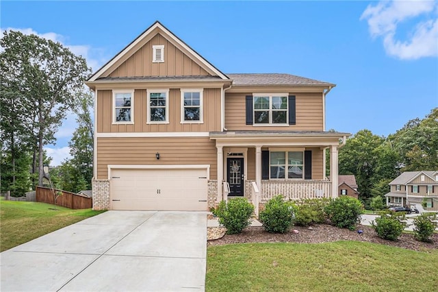 craftsman inspired home with a garage, a porch, and a front lawn