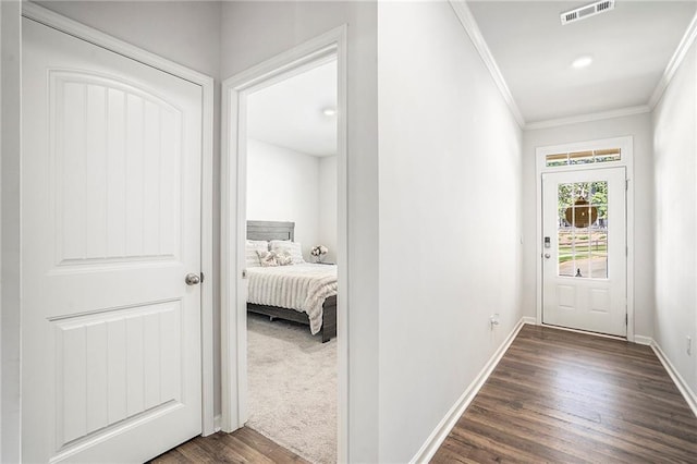 corridor featuring ornamental molding and dark hardwood / wood-style flooring