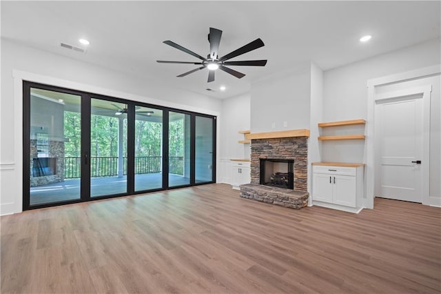 unfurnished living room featuring ceiling fan, light wood-style floors, a fireplace, and recessed lighting