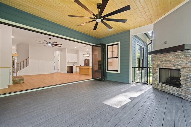 wooden terrace featuring ceiling fan