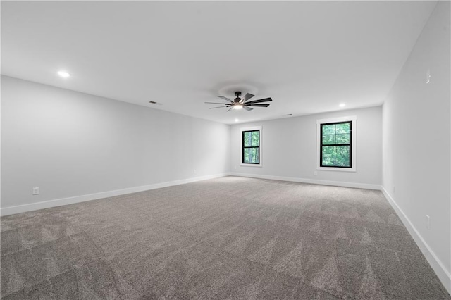 carpeted spare room featuring recessed lighting, ceiling fan, and baseboards