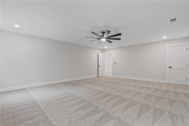 spare room featuring light colored carpet, recessed lighting, baseboards, and a ceiling fan
