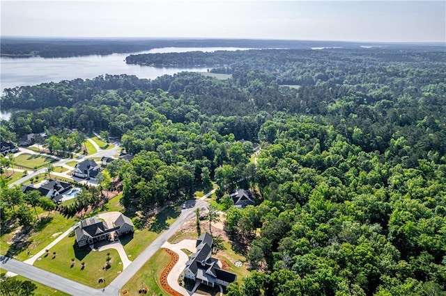 bird's eye view of a heavily wooded area and a nearby body of water