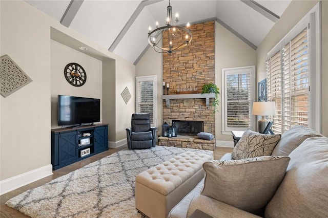 living room featuring a notable chandelier, high vaulted ceiling, a fireplace, and baseboards