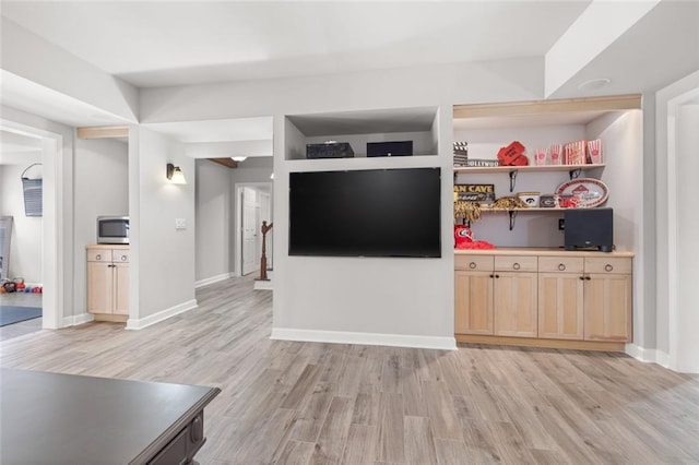 unfurnished living room with light wood-style floors and baseboards