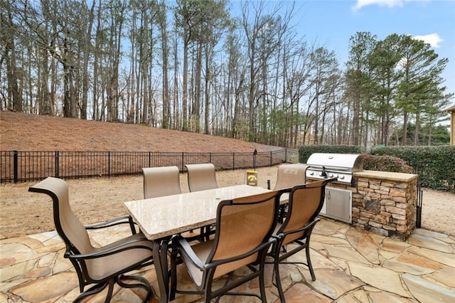 view of patio with outdoor dining area, area for grilling, and a fenced backyard