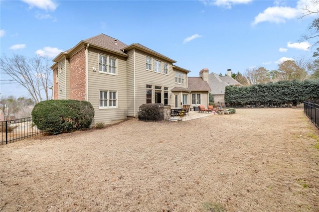 rear view of house featuring a patio area and a fenced backyard