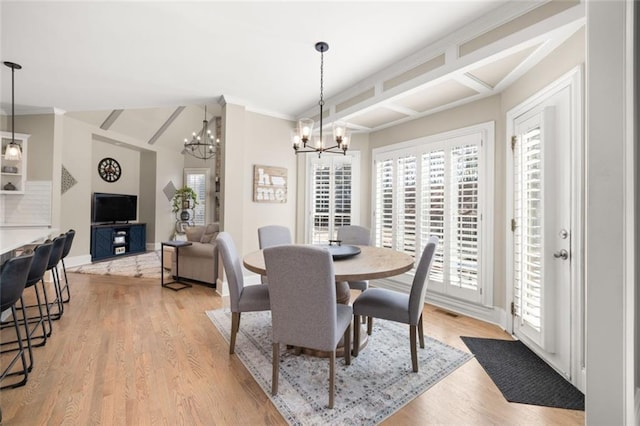 dining room featuring baseboards, light wood finished floors, visible vents, and a notable chandelier