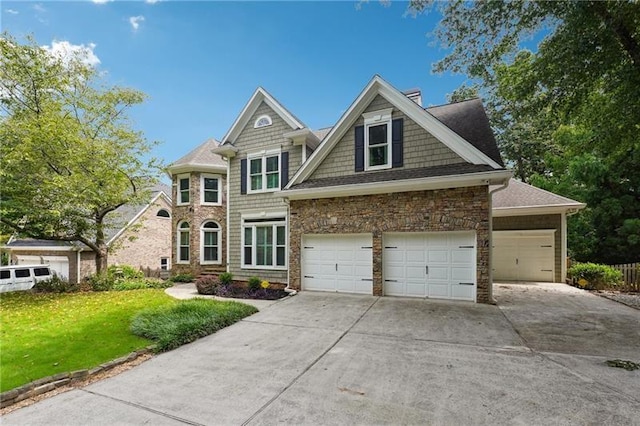 view of front of home with a garage and a front lawn