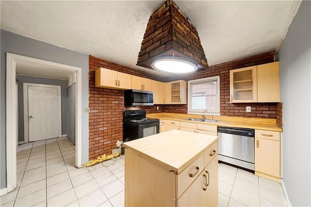 kitchen featuring appliances with stainless steel finishes, light brown cabinetry, sink, a kitchen island, and light tile patterned flooring