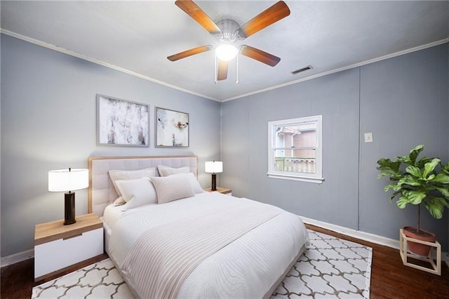 bedroom featuring ceiling fan, ornamental molding, and hardwood / wood-style flooring