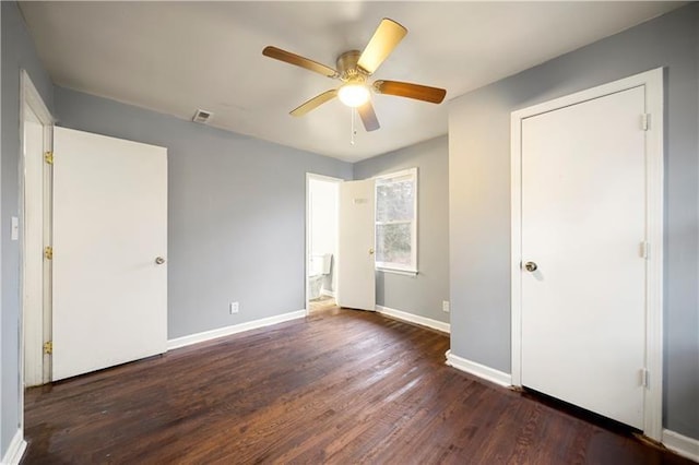 unfurnished bedroom featuring ceiling fan and dark hardwood / wood-style flooring