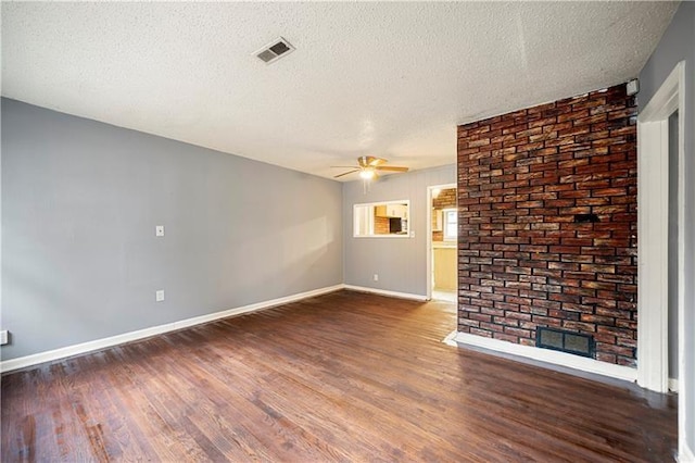 unfurnished living room featuring dark hardwood / wood-style floors, ceiling fan, a textured ceiling, and a fireplace