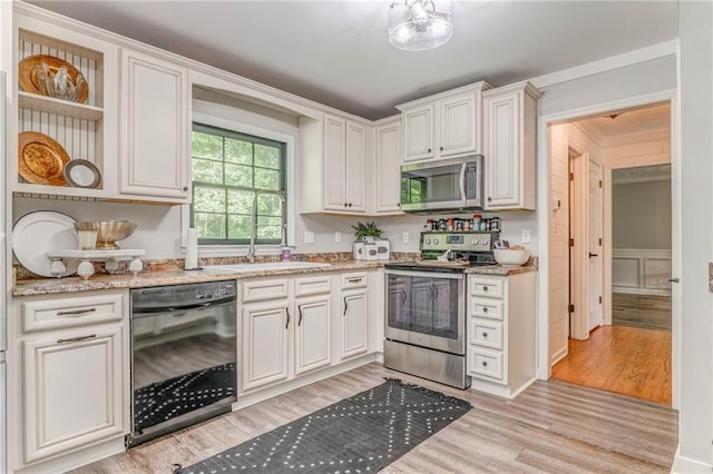 323 Schoolhouse Rd, Rockmart, GA 30153 - kitchen featuring appliances with stainless steel finishes, open shelves, light wood-style floors, light stone counters, and white cabinets