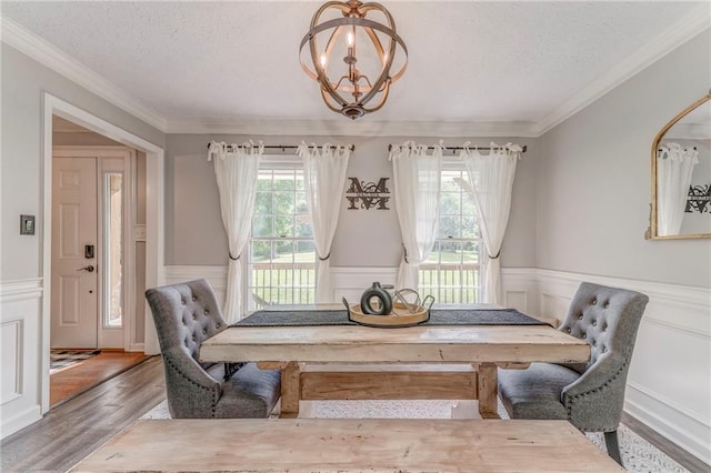 323 Schoolhouse Rd, Rockmart, GA 30153 - dining room featuring a textured ceiling, wainscoting, wood finished floors, ornamental molding, and a chandelier