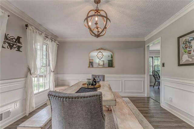 323 Schoolhouse Rd, Rockmart, GA 30153 - dining room with a chandelier, dark wood-type flooring, wainscoting, a textured ceiling, and crown molding