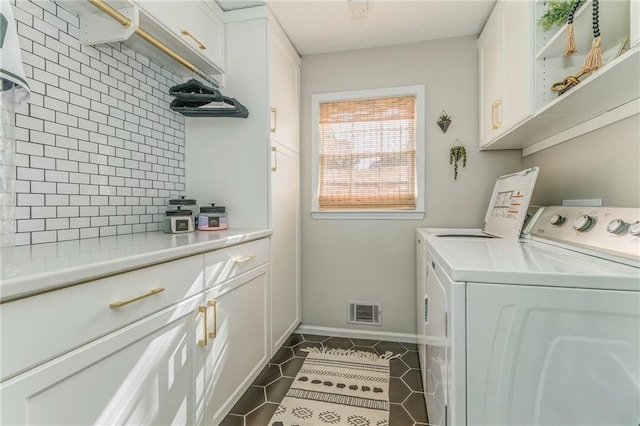 323 Schoolhouse Rd, Rockmart, GA 30153 - washroom with independent washer and dryer, cabinet space, and dark tile patterned flooring