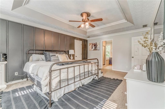 323 Schoolhouse Rd, Rockmart, GA 30153 - bedroom with a tray ceiling, ornamental molding, a textured ceiling, light carpet, and a ceiling fan
