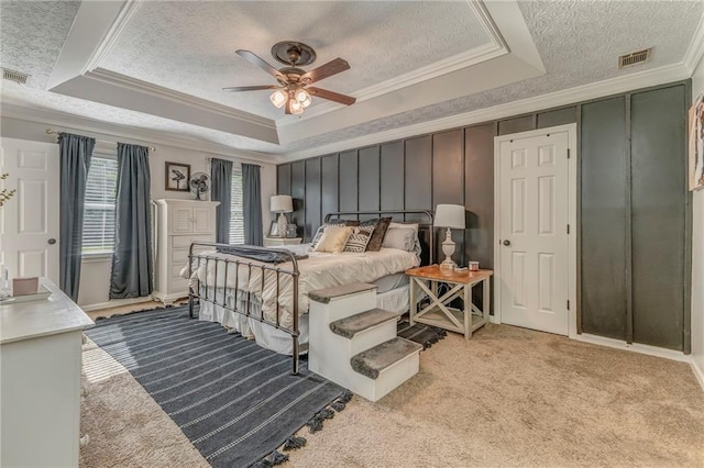 323 Schoolhouse Rd, Rockmart, GA 30153 - bedroom with a textured ceiling, crown molding, a tray ceiling, light carpet, and ceiling fan