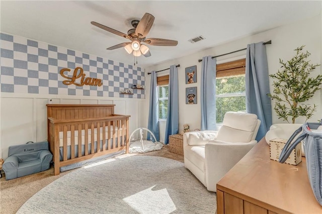 323 Schoolhouse Rd, Rockmart, GA 30153 - bedroom with carpet floors, wallpapered walls, a ceiling fan, a nursery area, and a decorative wall