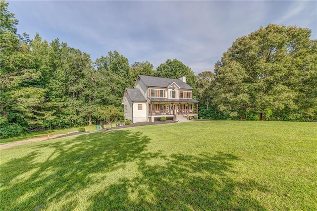 323 Schoolhouse Rd, Rockmart, GA 30153 - colonial inspired home featuring a porch, a front yard, a forest view, and a chimney