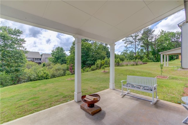 view of patio / terrace featuring view of wooded area