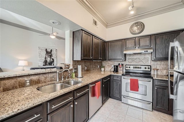 kitchen with stainless steel appliances, light stone countertops, sink, and light tile patterned floors