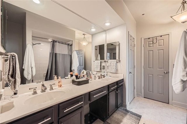 bathroom featuring tile patterned flooring, vanity, and curtained shower