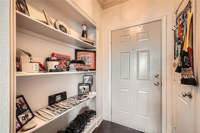 interior space with ornamental molding and dark hardwood / wood-style flooring