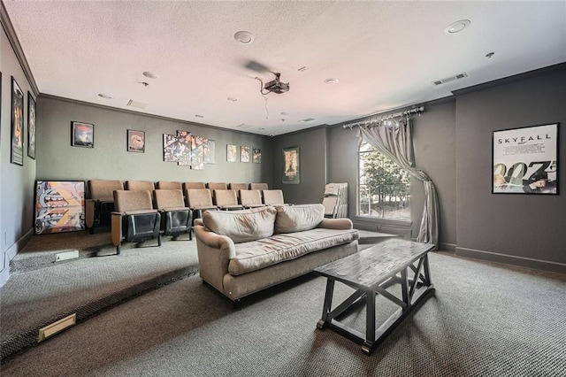 home theater room featuring ornamental molding, carpet flooring, and a textured ceiling