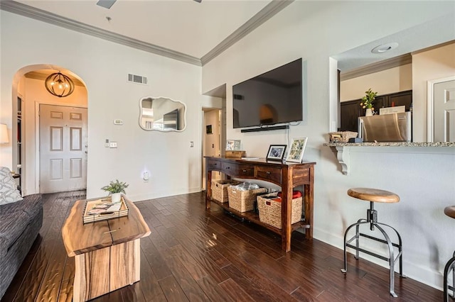 living room featuring crown molding and dark hardwood / wood-style floors