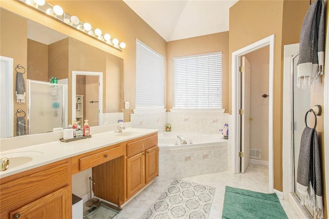 bathroom with tile patterned flooring, vaulted ceiling, independent shower and bath, and vanity