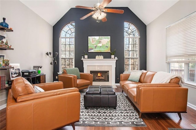 living room with vaulted ceiling, ceiling fan, a wealth of natural light, and dark hardwood / wood-style floors