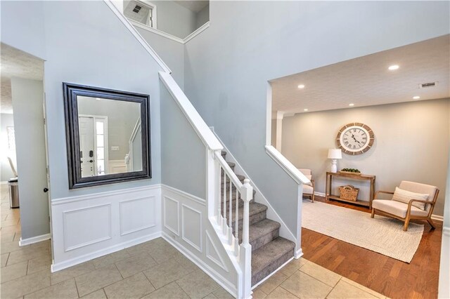 1510 Ridgemill Ter, Dacula, GA 30019 - stairs with tile patterned flooring, recessed lighting, and a high ceiling