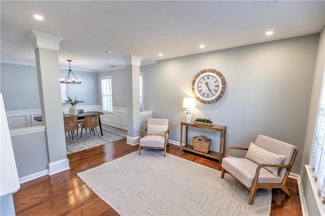1510 Ridgemill Ter, Dacula, GA 30019 - living area featuring ornate columns, crown molding, wood finished floors, recessed lighting, and wainscoting
