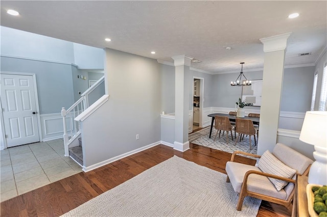 1510 Ridgemill Ter, Dacula, GA 30019 - sitting room with stairs, crown molding, wood finished floors, a chandelier, and recessed lighting