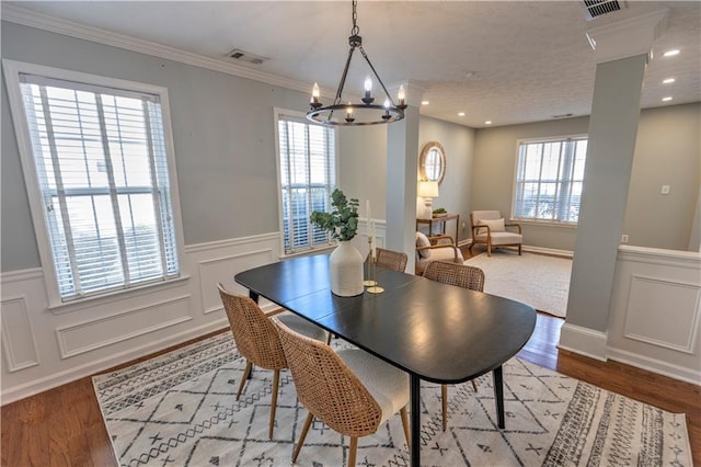 1510 Ridgemill Ter, Dacula, GA 30019 - dining area with a chandelier, plenty of natural light, wainscoting, wood finished floors, and a decorative wall