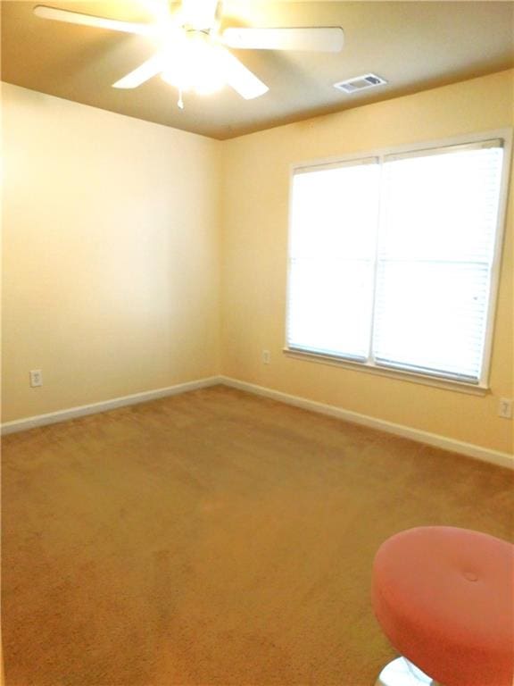 carpeted empty room featuring ceiling fan