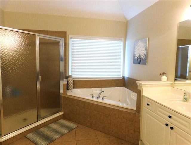 bathroom with tile patterned floors, vanity, lofted ceiling, and plus walk in shower