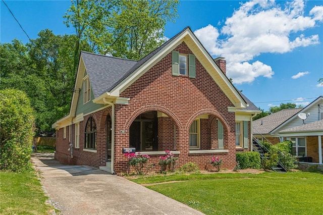 1391 Jefferson Ave, East Point, GA 30344 - view of front of property with brick siding, a chimney, a front lawn, a shingled roof, and a porch
