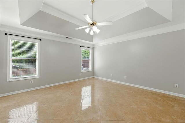 314 Spring Falls Dr, Lawrenceville, GA 30045 - empty room featuring a tray ceiling, light tile patterned flooring, crown molding, and ceiling fan