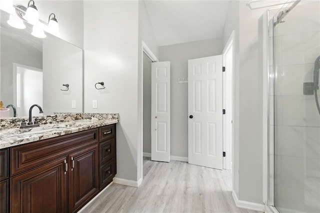 314 Spring Falls Dr, Lawrenceville, GA 30045 - full bath featuring double vanity, wood finished floors, and a shower stall