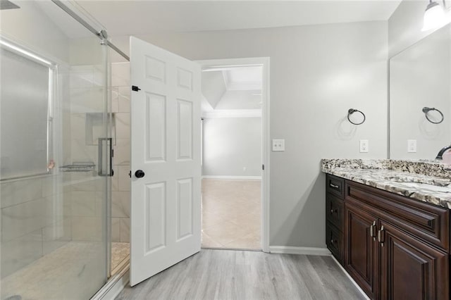 314 Spring Falls Dr, Lawrenceville, GA 30045 - bathroom with vanity, a shower stall, and wood finished floors
