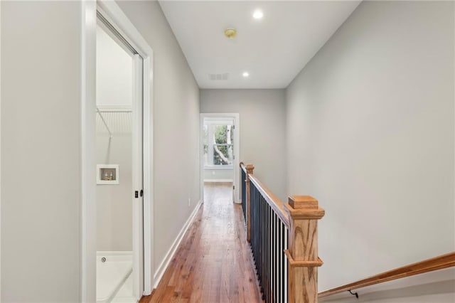 hallway featuring an upstairs landing, light wood-style flooring, recessed lighting, and baseboards
