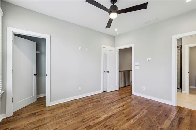 unfurnished bedroom featuring wood finished floors, baseboards, recessed lighting, and ceiling fan